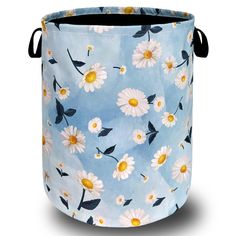 a blue and white bucket with daisies on it