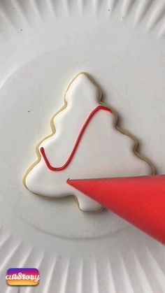 a white plate topped with a cookie shaped like a mountain next to a red piece of paper