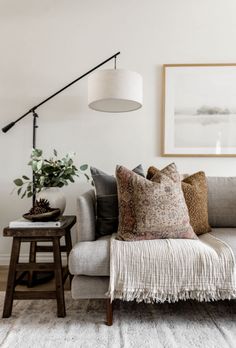 a living room filled with furniture and a lamp