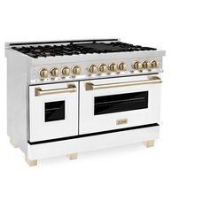 a white stove top oven with two burners on each side and gold knobs