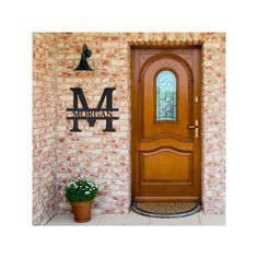 a wooden door sitting on the side of a brick wall next to a potted plant