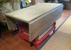 a wooden table sitting on top of a hard wood floor