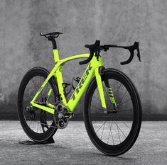 a yellow and black bike parked in front of a wall