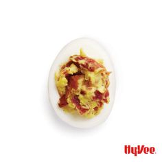 an egg with bacon and eggshells on it