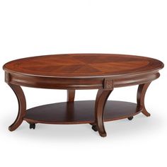 an oval coffee table with wheels on the bottom and one shelf underneath it, in dark wood