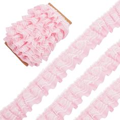 three pieces of pink ruffled garters on a white background