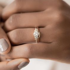 a woman's hand holding a diamond ring