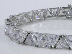 Gorgeous Handmade Bracelet, trillion diamond style cz stones, 18K White Gold plated on Silver. Perfect gift for you or your significant other, great for all kinds of occasions and celebrations! Elegant jewelry box included. Party Diamond Cut Tennis Bracelet, Dazzling Diamond Cut Tennis Bracelet For Party, Dazzling Diamond-cut Tennis Bracelet For Party, Dazzling Cubic Zirconia Diamond Bracelet As A Gift, Gift Tennis Bracelet With Diamond Accents, Cubic Zirconia Tennis Bracelet With Diamond Accents As Gift, Brilliant Cut Cubic Zirconia Diamond Bracelet For Party, Gift Tennis Bracelet With Diamond Accents And Cubic Zirconia, Party Diamond Bracelet With Prong Setting In Cubic Zirconia