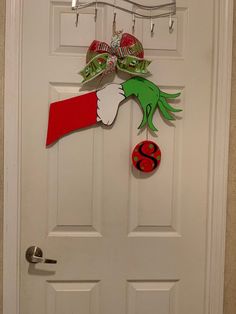 the door is decorated with an elf's hand holding a christmas ornament