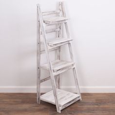 a white wooden ladder leaning against a wall