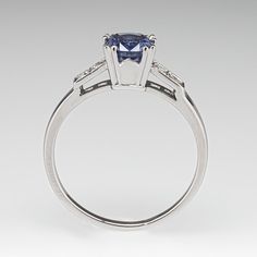 This alluring ring is centered with a no heat Tanzanian sapphire weighing 1.75 carats that we sourced and set in an elegant vintage platinum mounting. The shoulders of the ring are each accented with two (2), bead set, old European/single cut diamonds. The ring measures 7.0mm at the top, rises 7.2mm above the finger, tapering to 1.6mm wide and 1.2mm thick at the base of the shank. This ring is currently a size 9.75. Sapphire Engagement Ring Vintage, Vintage Engagement Rings Sapphire, Engagement Ring Vintage, Sapphire Engagement Ring, Bead Set, No Heat, August Birth Stone, Sapphire Engagement, Engagement Rings Sapphire