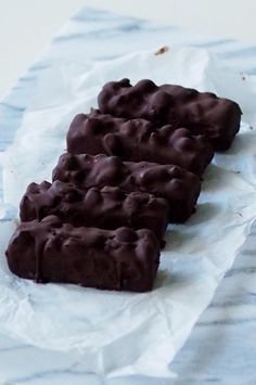 three pieces of chocolate sitting on top of wax paper