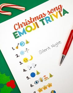 a christmas song emotriva sheet next to a pen and candy canes