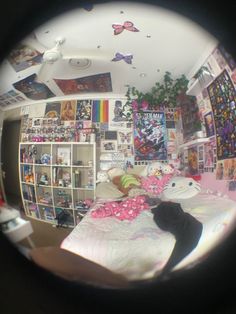 the view through a fish eye lens shows a bedroom with comic books on the wall