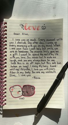 a note with an elephant drawn on it next to a pen