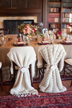 the table is set with two chairs and one has a crocheted blanket draped over it