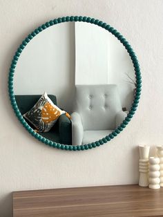 a mirror that is on the wall above a couch