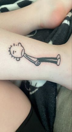 a person with a dog bone tattoo on their arm and leg, laying down next to each other