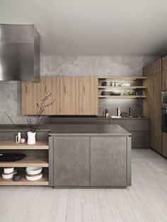 a modern kitchen with stainless steel appliances and wooden cabinets