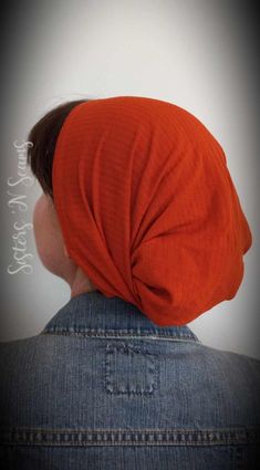 a woman wearing an orange turban on top of her head