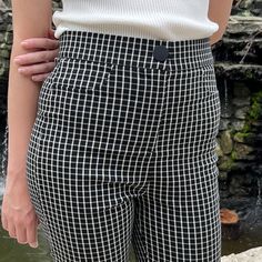 Add modern style to your wardrobe with these checkered-pattern skinny leg pants. Featuring decorative pockets, a snap button and a high waist, these are designed to be both comfortable and flattering. The black and white checkered print adds a urban styling, taking them from work to date night. Small is 28.5" inseam and 28.5" waist. Stretchy, but go up a size if you have bigger hips. Made in China 75% rayon; 22% polyester; 3% spandex Hand wash cold Chic Plaid Bottoms For Business Casual, Chic Stretch Plaid Bottoms, Trendy High Waist Houndstooth Bottoms, Chic Houndstooth High-waisted Pants, Trendy Plaid Ankle-length Bottoms, Trendy Ankle-length Plaid Bottoms, Chic Stretch Houndstooth Bottoms, Black Houndstooth Office Pants, Trendy Fitted Houndstooth Bottoms