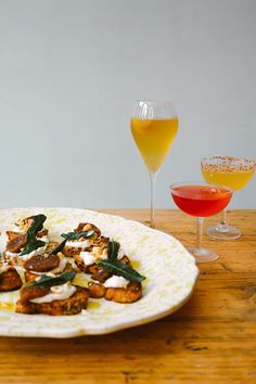 there is a plate with food and two glasses on the table