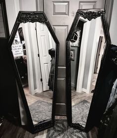 two mirrors sitting on top of a rug in front of a door and a doorway