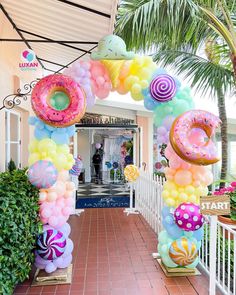 an entrance decorated with balloons and donuts