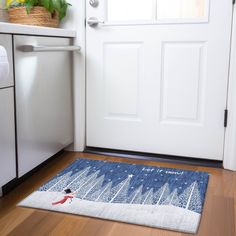 a door mat with a snowman on it in front of a white door and a dishwasher