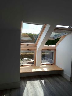 an empty room with two skylights in it