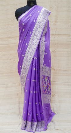 Add traditional hues to your wardrobe with Khinkhwab’s exclusive range of georgette sarees perfect to complete that regal look this season. This exclusive pure georgette Handloom Banarasi Silk saree has small silver zari dollar booties all over and an intricately woven floral silver zari border that adds to its beauty and grace. Purple Georgette Saree With Pallu, Unstitched Purple Georgette Saree, Semi-stitched Georgette Saree With Zari Weaving, Purple Georgette Saree With Cutdana, Eid Saree With Zari Weaving In Georgette, Eid Georgette Saree With Zari Weaving, Traditional Pre-draped Saree With Sheer Dupatta In Purple, Traditional Purple Pre-draped Saree With Sheer Dupatta, Purple Georgette Traditional Wear With Zari Weaving