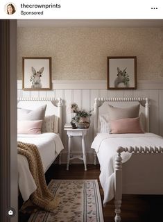 two white beds in a bedroom with pink and white decor on the headboard, nightstands and rug