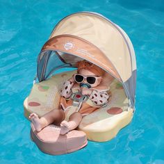 a baby is sitting in a pool with sunglasses on and it's head up