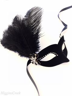 Feather Masquerade Mask in Black Velvet fabric adorned with Ostrich Plumes, beadwork, pearls and rhinestones. Elegant and beautiful addition to complete your beaded masquerade Ball Gown or Prom Masquerade Dress. Perfect for Flapper style Roaring 20s dresses! The Mask colors can be customized. Lightweight base in soft black velvet fabric & embellished with Crystal rhinestones. You have the option to add feathers with matching bead-work. The Feather colors can be customized to match your dress Masquerade Mask Prom, Prom Masquerade, Mask Prom, White Masquerade Mask, Roaring 20s Dresses, Masquerade Mask Women, Masquerade Dress, Masquerade Ball Masks, Black Masquerade Mask