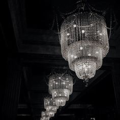 chandeliers hanging from the ceiling in a dark room