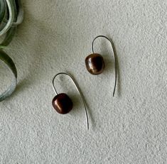 These delicate threader earrings are made of 14k gold filled wire and beautiful chocolate colored freshwater pearls. The variation in the pearl enhances the sleek and modern feel of these earrings. Length of the earring is approximately 1.25 inches Also available in 14k Gold Fill and white pearl: https://www.etsy.com/listing/663494445/pearl-threader-earrings-i-pearl-earrings Brown Pearl Drop Jewelry Gift, Brown Pearl Drop Jewelry For Gift, Brown Pearl Drop Earrings As Gift, Brown Pearl Drop Earrings For Gift, Pearl Threader Earrings, Chocolate Pearls, Silver Threader Earrings, Beautiful Chocolate, Freshwater Pearl Jewelry