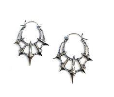 Add some gothic style to your wardrobe with these unique Chaos Earrings. Made in sterling silver, these earrings feature 5 spikes contrasted by a heavy textured crescent. Dimensions These earrings are 45mm long x 36mm wide and 5mm thick Each earring weighs approximately 6.5grams Edgy Silver Earrings For Festival, Silver Gothic Plug Earrings For Festival, Gothic Oxidized Metal Earrings, Edgy Silver Sterling Silver Plug Earrings, Edgy Sterling Silver Plug Earrings, Edgy Silver Jewelry With Spikes, Gothic Metal Jewelry With Spikes, Gothic Silver Earrings With Oxidized Finish, Silver Gothic Hoop Earrings