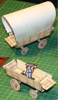 paper model of a man riding in a horse drawn wagon