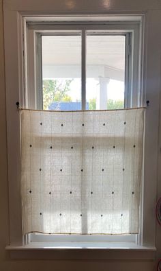 a white window with polka dots on it