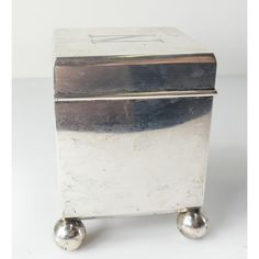 an old silver box with two metal balls on it