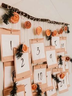 several pieces of paper hanging on a wall with numbers and oranges attached to them