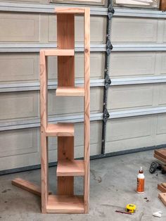 a wooden shelf sitting in front of a garage door