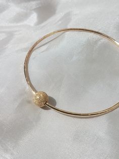 Thick 14G bangles with 1 gold filled accent beads. Available in 16G for $10 less. Also available in silver, just message me. Available in silver for $35. Looks great paired with other bangles. https://www.etsy.com/listing/106162524/custom-14g-bangle-gold-filled Found some special shells on your vacation and want to create a special piece; we can work together to make something you love!! Custom orders welcome, just message me. All jewelry come gift wrapped. Gold Beaded Bangle Jewelry As Gift, Gold Beaded Bangle Jewelry For Gift, Hypoallergenic Gold Bangle Jewelry, Gold Beaded Bangle Jewelry, Elegant Gold Nickel-free Bangle, Hypoallergenic Gold Round Bangle, Hypoallergenic Gold Bangle, Minimalist Gold Hoop Bangle, Gold Hoop Bangle In Minimalist Style