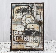 a card with an old timey car and clock on the front, sitting on a lace doily