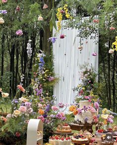 a table filled with cakes and desserts covered in flowers