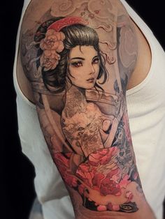 a woman with tattoos on her arm and shoulder