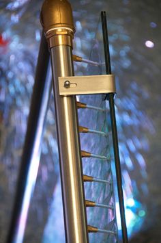 a close up view of a metal pole with fireworks in the back ground behind it