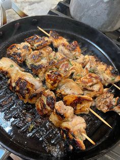 chicken skewers are being cooked on a grill