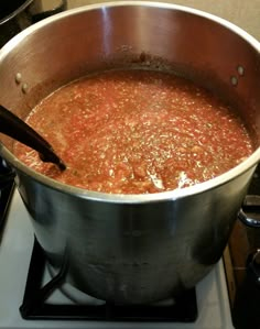 a pot filled with soup sitting on top of a stove