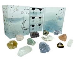 an assortment of crystals and rocks are shown in front of a box with its contents